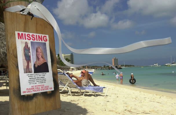 PHOTO: In this June 10, 2005, file photo, a missing poster of Natalee Holloway, an Alabama high school graduate who disappeared while on a graduation trip to Aruba, is seen on Palm Beach, in front of her hotel in Aruba. (Leslie Mazoch/AP, FILE)