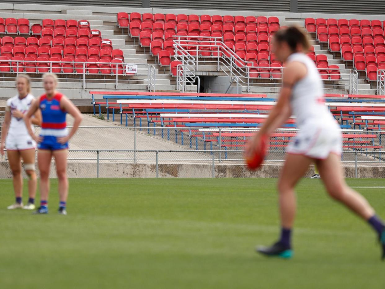 Empty seats are seen due to the coronavirus outbreak during an AFL womens' match: via Getty Images