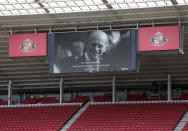 Sunderland and Charlton Athletic players stand for a two minute silence following the death of Britain's Prince Philip, the Duke of Edinburgh yesterday, ahead of the League One soccer match at at the Stadium of Light, Sunderland, England, Saturday April 10, 2021. (Richard Sellers/PA via AP)