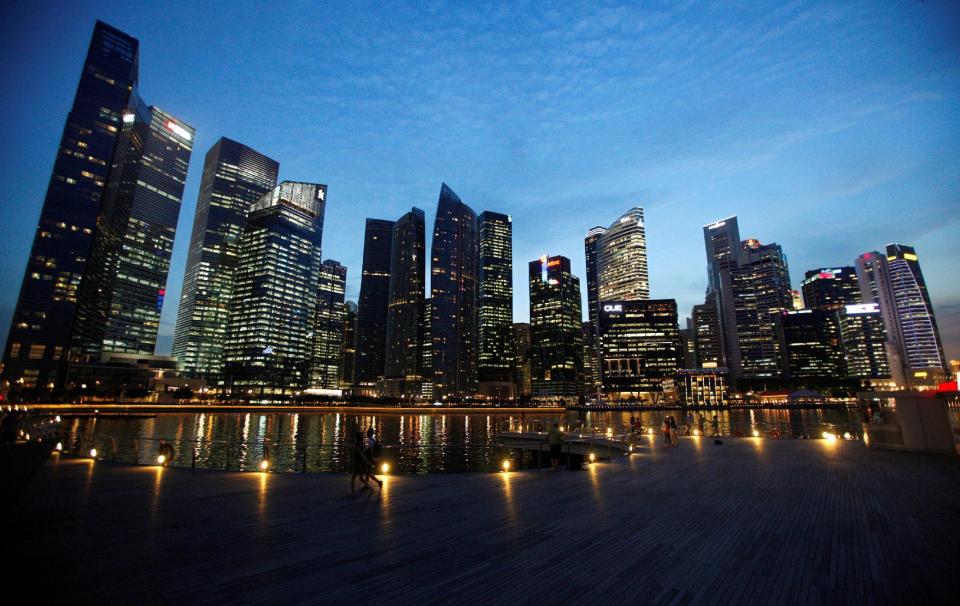 People walking past Marina Bay. (File photo: Reuters/Edgar Su)