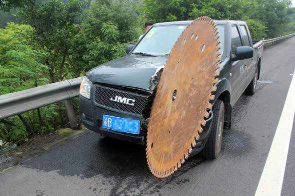 Mandatory Credit: Photo by Imaginechina/REX Shutterstock (4850359a)The car with the circular saw blade sticking out of itCircular saw blade slices into car after falling off truck, Chongqing, China - 17 Jun 2015A man in western China had a close shave after his car was hit by a massive circular saw blade while he was driving along the road. The motorist was driving to Chongqing when he heard a bang come from the opposite lane before spotting a huge circular bouncing through the bushes of the central reservation. The blade then smashed into the front of his vehicle, slicing around 50cm into the bonnet. Highway police said another truck had crashed in the opposite lane and the blade had been thrown off the vehicle and into the road.