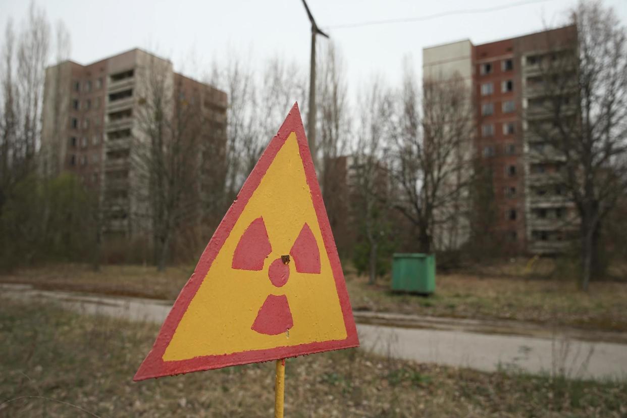 A sign warns of radiation contamination near former apartment buildings in Pripyat, 30 years on from the Chernobyl disaster: Getty Images