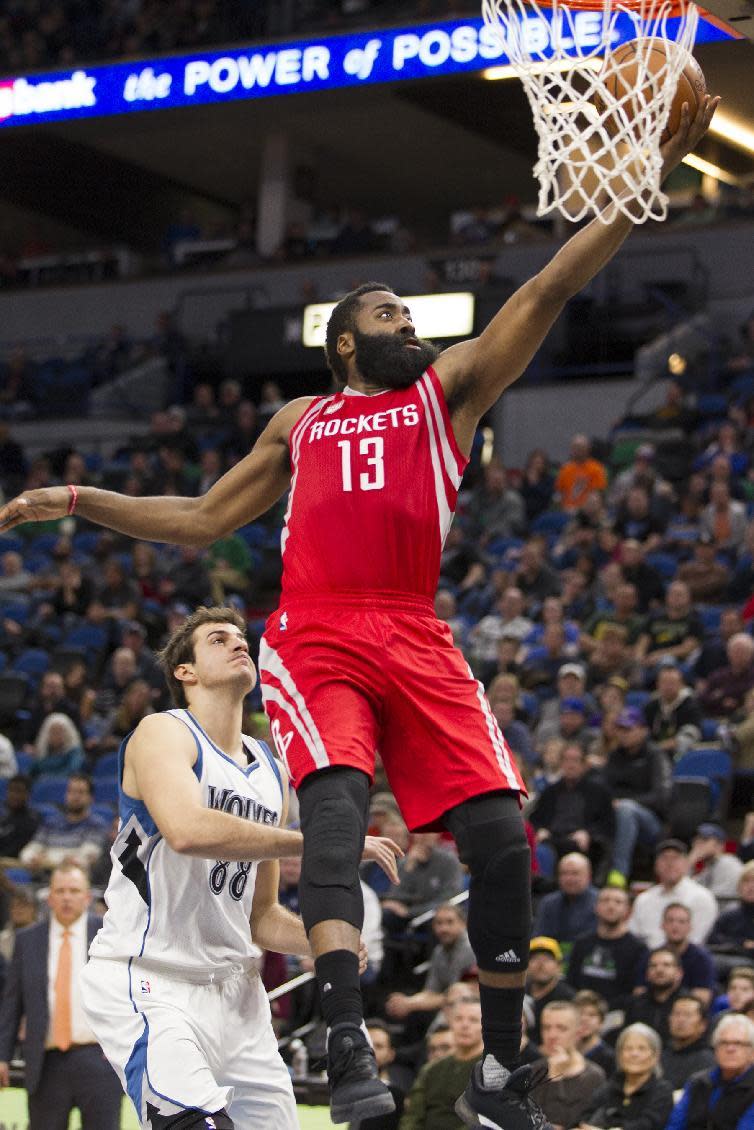 Houston Rockets guard James Harden (13) scores during the second half of an NBA basketball game as Minnesota Timberwolves forward Nemanja Bjelica (88), of Serbia looks on Saturday, Dec. 17, 2016, in Minneapolis. Houston won 111-109 in overtime. (AP Photo/Paul Battaglia)