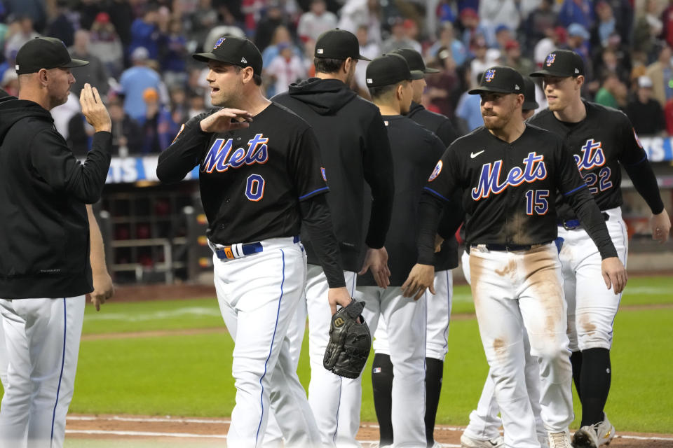 The New York Mets celebrate after defeating the Philadelphia Phillies 4-3 during the first game of a baseball doubleheader Saturday, Sept. 30, 2023, in New York. (AP Photo/Mary Altaffer)