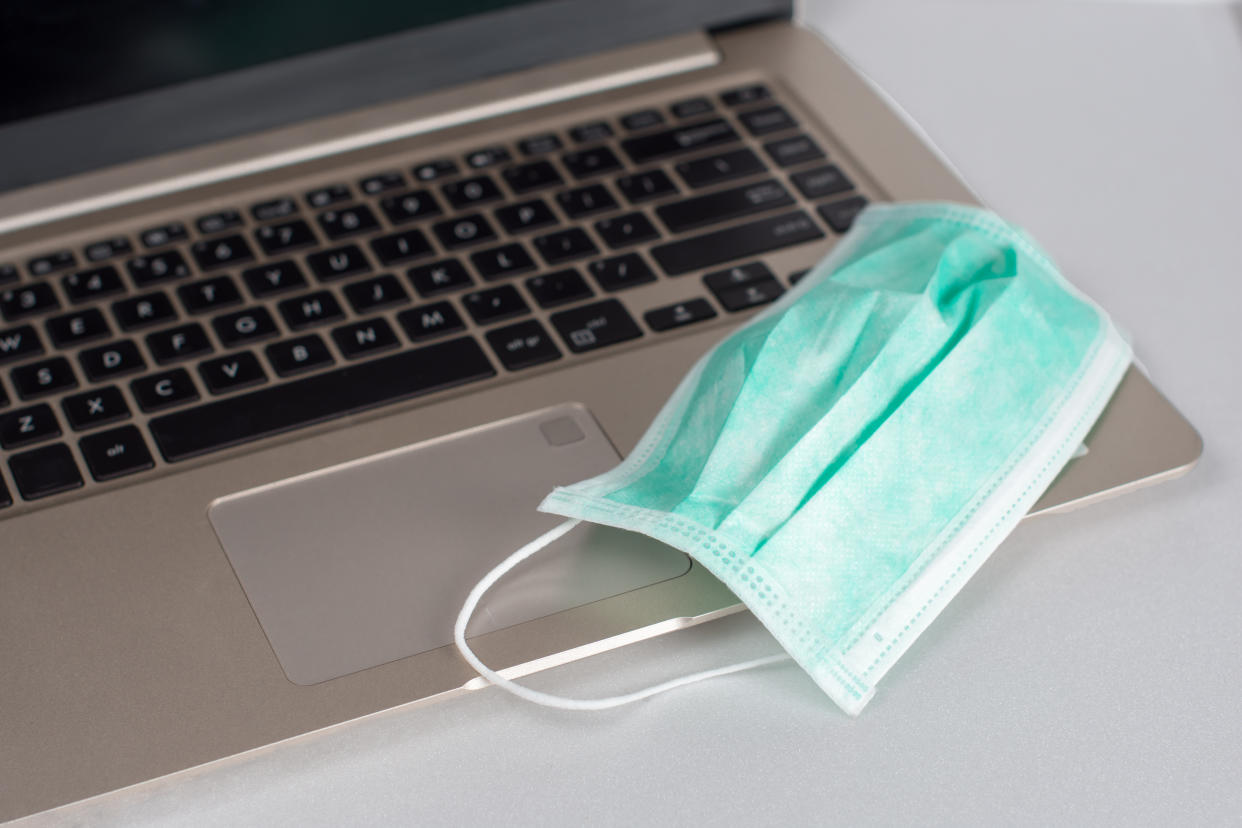 Medical breathing mask on laptop for  home office