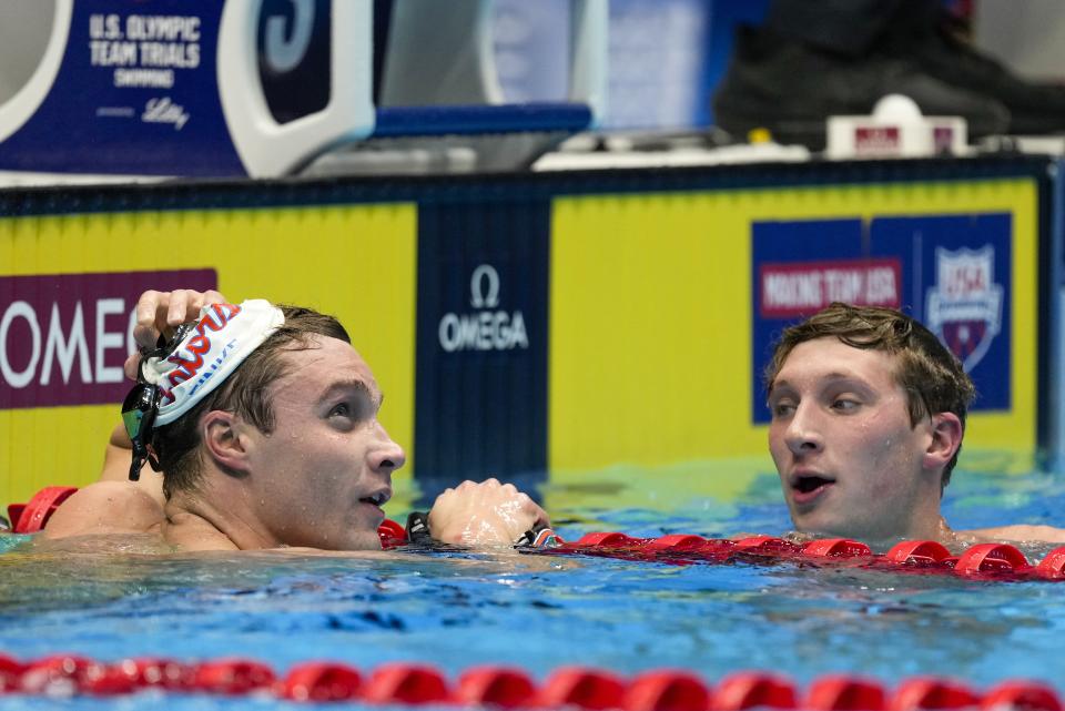 David Johnston congratulates Robert Finke after a Men's 1500 freestyle preliminary heat Saturday, June 22, 2024, at the US Swimming Olympic Trials in Indianapolis. (AP Photo/Michael Conroy)