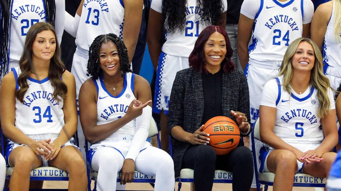 University of Kentucky basketball player Robyn Benton, second from left, and head coach Kyra Elzy, second from right, share a laugh during the team’s photo day at the Joe Craft Center on Wednesday.