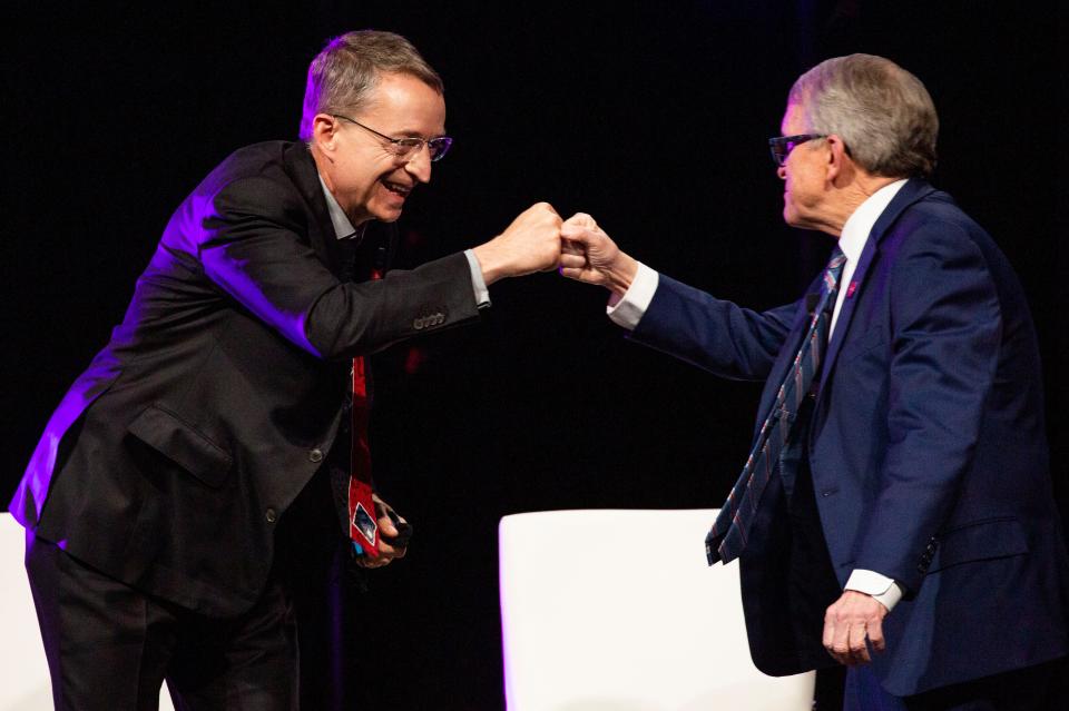 Ohio Governor Mike DeWine receives a fist bump from Intel President and CEO Pat Gelsinger during an announcement that Intel will be investing 20 billion dollars building two computer chip factories in Jersey Township, in Licking County, during a live televised a presentation at the Midland Theatre in Newark, Ohio on January 21, 2022.