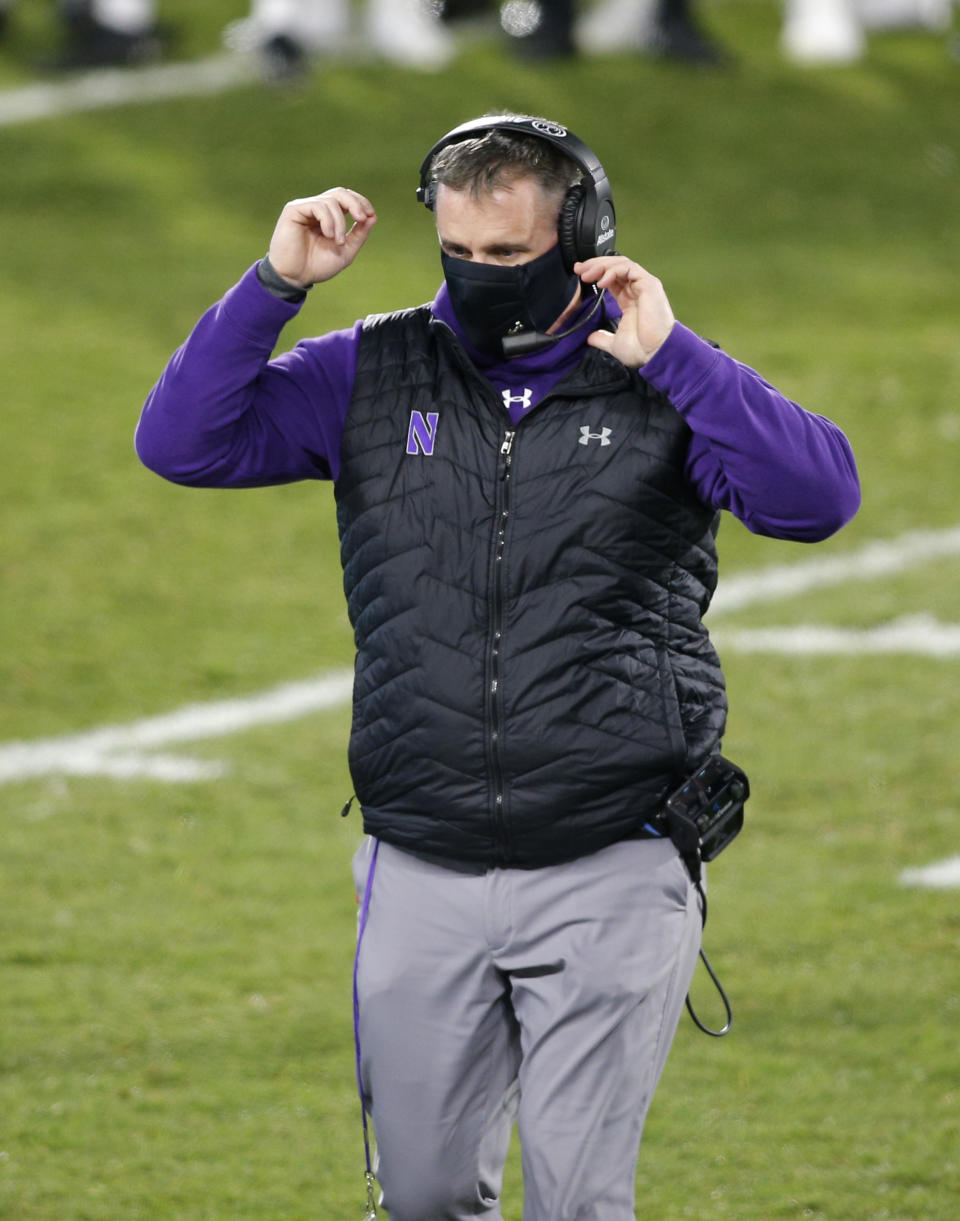 Northwestern coach Pat Fitzgerald walks on the field during the fourth quarter of the team's NCAA college football game against Michigan State, Saturday, Nov. 28, 2020, in East Lansing, Mich. Michigan State won 29-20. (AP Photo/Al Goldis)