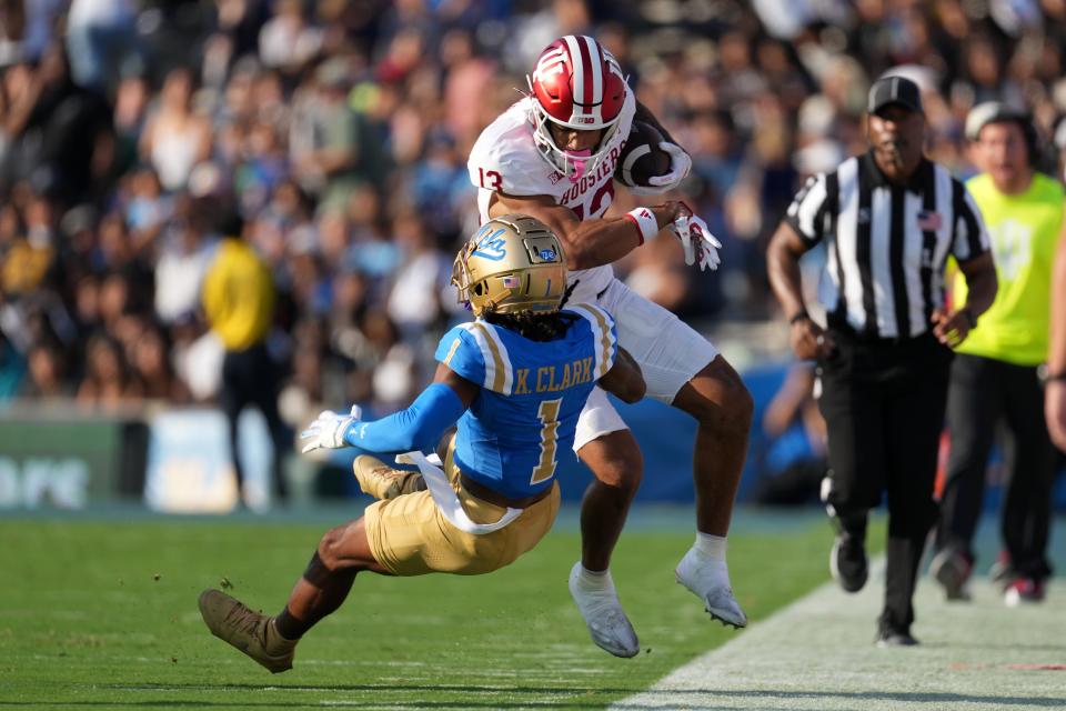 Indiana Hoosiers wide receiver Elijah Sarratt (13) carries the ball against UCLA Bruins defensive back Kanye Clark (1) in the first half at the Rose Bowl on Saturday in Pasadena, California.