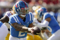 Mississippi quarterback Matt Corral (2) hands off to a teammate during the first half of an NCAA college football game against LSU in Oxford, Miss., Saturday, Oct. 23, 2021. (AP Photo/Rogelio V. Solis)