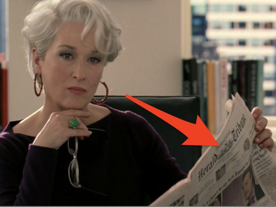 meryl streep as miranda in devil wears prada looking unamused while flipping through a newspaper