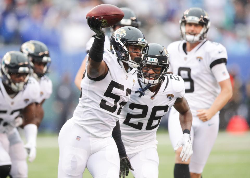 Sep 9, 2018; East Rutherford, NJ, USA; Jacksonville Jaguars linebacker Donald Payne (52) celebrates his fumble recover with defensive back Jarrod Wilson (26) during the second half at MetLife Stadium. Mandatory Credit: Vincent Carchietta-USA TODAY Sports