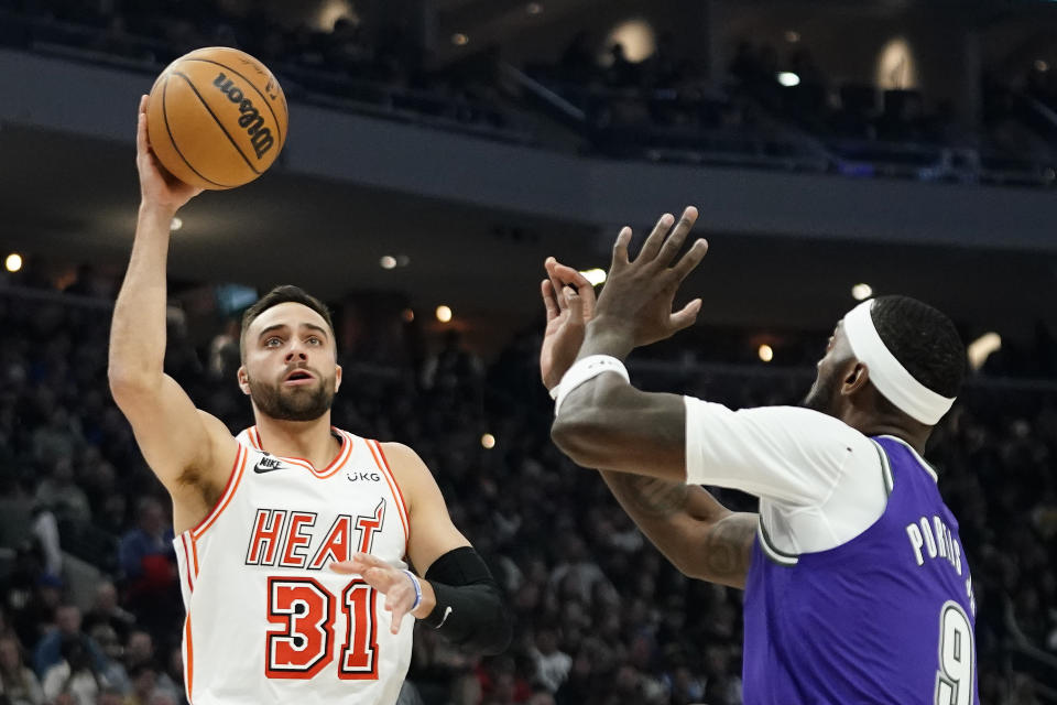 Miami Heat's Max Strus (31) shoots against Milwaukee Bucks' Bobby Portis during the first half of an NBA basketball game Friday, Feb. 24, 2023, in Milwaukee. (AP Photo/Aaron Gash)