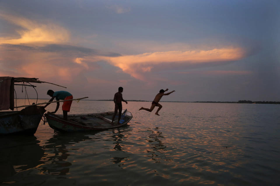 <p>A person jumps in the flooded river Ganges in Allahabad, India, Aug. 25, 2016. Heavy monsoon rains have ended two successive drought years in India with the Ganges River and its tributaries rising above the danger level, triggering evacuation of hundreds of thousands of people from flooded homes in north and eastern India. (Photo: Rajesh Kumar Singh/AP)</p>