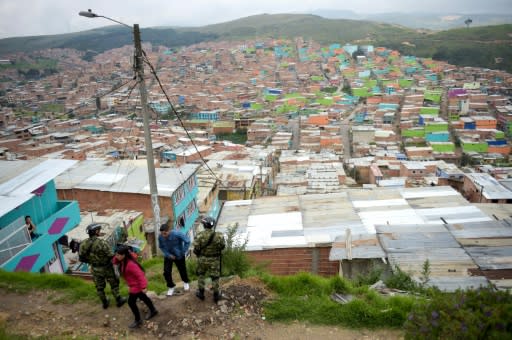 Colombian soldiers stand guard at the Ciudad Bolivar slum outside Bogota -- it is home to 700,000 people