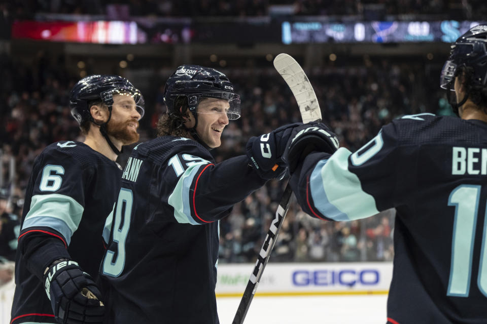 Seattle Kraken forward Jared McCann, center, celebrates with defenseman Adam Larsson, left, and forward Matty Beniers after scoring a goal against the St. Louis Blues during the second period of an NHL hockey game Tuesday, Dec. 20, 2022, in Seattle. (AP Photo/Stephen Brashear)