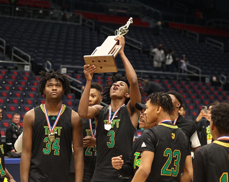 Taft forward Rayvon Griffith holds up the championship trophy after the Senators defeated Ottawa-Glandorf in the OHSAA Division III final game March 20. Griffith will return to the area at the Flyin' To The Hoop Invitation in Kettering Jan. 13. He is a University of Cincinnati commit.