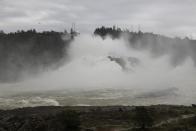 Water gushes down the Oroville Dam's main spillway Wednesday, Feb. 15, 2017, in Oroville, Calif. The Oroville Reservoir is continuing to drain Wednesday as state water officials scrambled to reduce the lake's level ahead of impending storms. (AP Photo/Marcio Jose Sanchez)