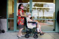 People line up at a polling station as early voting begins in Florida