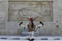 Evzones of the Greek Presidential Guard in front of the Tomb of the Unknown Soldier in Athens Greece, Tuesday, Aug. 3, 2021. Authorities in Greece have closed the Acropolis and other ancient sites during afternoon hours as a heatwave scorching the eastern Mediterranean continued to worsen. Temperatures reached 42 C (107.6 F) in parts of the Greek capital, as the extreme weather fueled deadly wildfires in Turkey and blazes across the region. (AP Photo/Michael Varaklas)