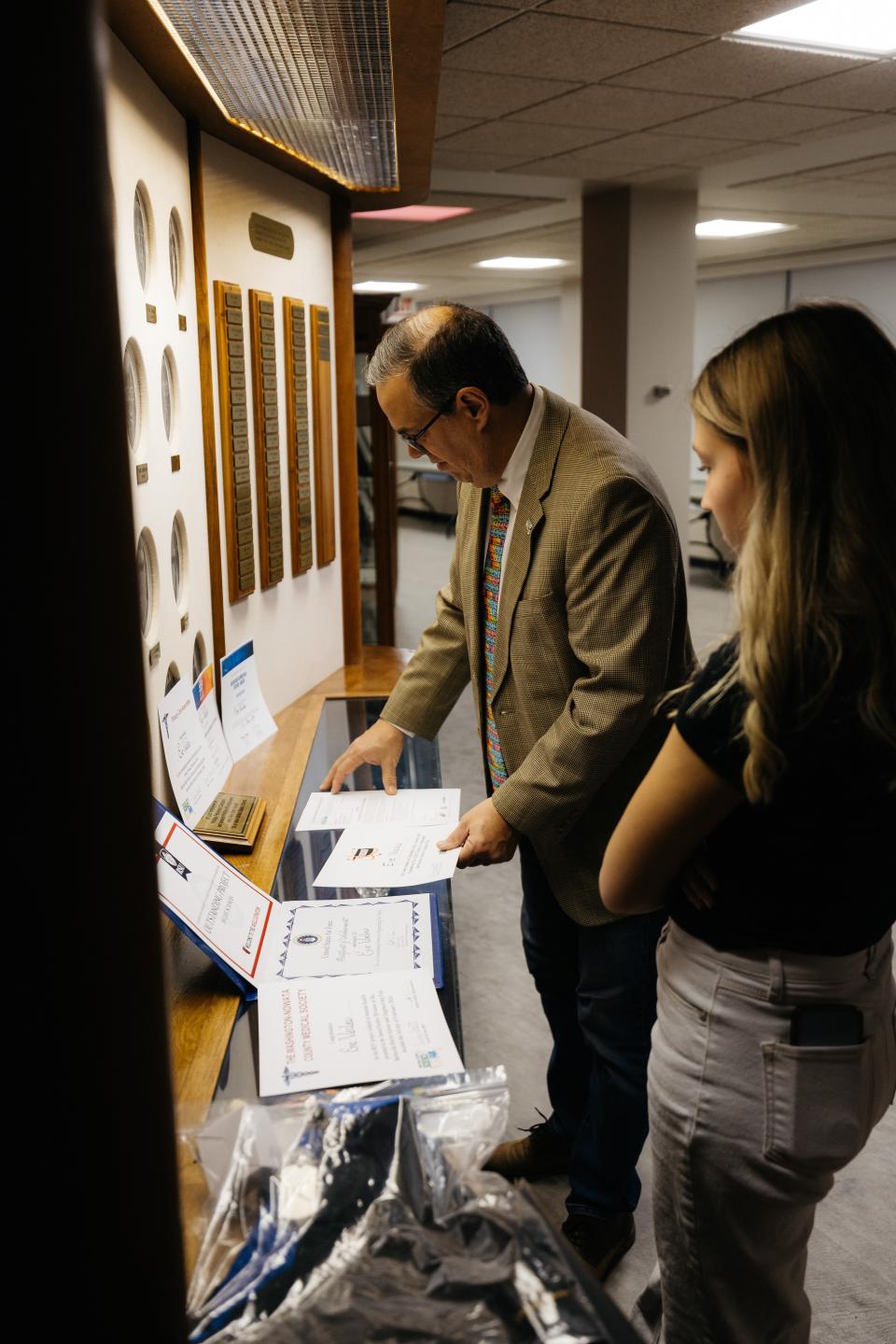 Tyler Vaclaw lays out all the awards his daughter, Eve Vaclaw, won at the 2024 Bartlesville District Science Fair.