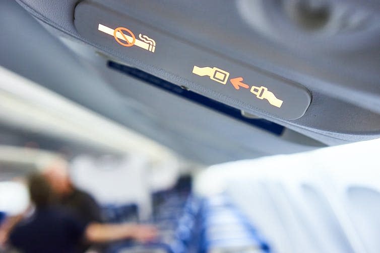 Fasten Seat belt sign on a plane.