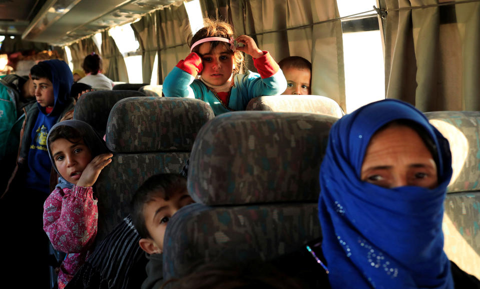 <p>People who just fled a village controlled by Islamic State militants sit in a bus before heading to a camp at Hamam al-Alil, south of Mosul, Iraq. Feb. 22, 2017. (Zohra Bensemra/Reuters) </p>