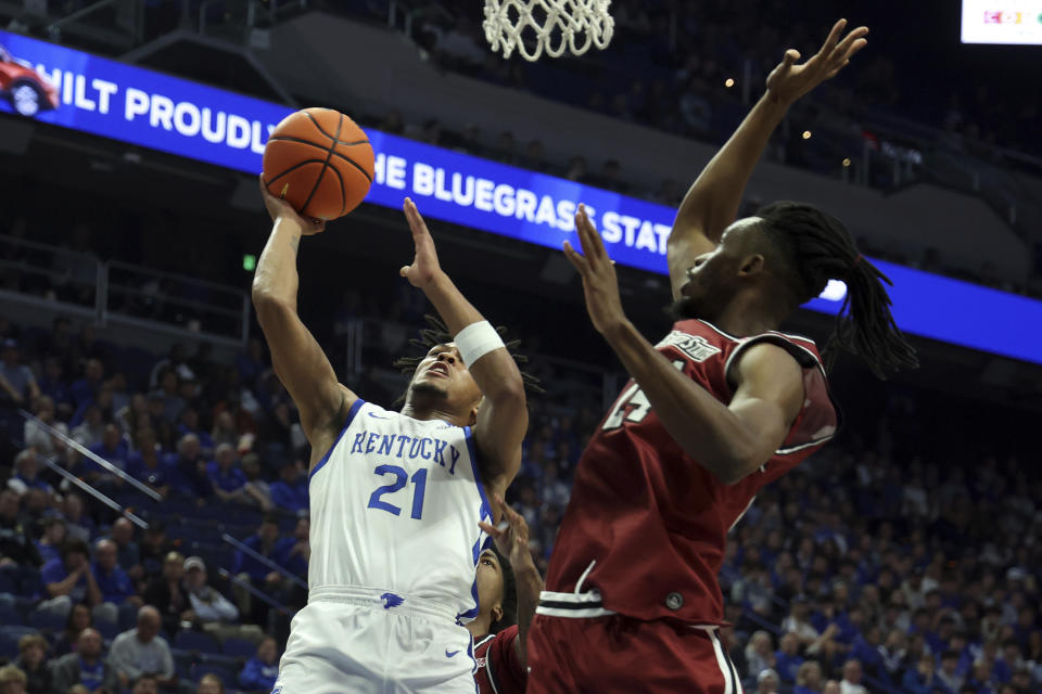 Kentucky's D.J. Wagner (21) shoots while defended by New Mexico State's Jonathan Kanyanga, right, during the first half of an NCAA college basketball game in Lexington, Ky., Monday, Nov. 6, 2023. (AP Photo/James Crisp)