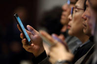 Shareholders use their Samsung Electronics Co. smartphones during the companyÕs extraordinary general meeting of shareholders at the Seocho office building in Seoul, South Korea, on Thursday, Oct. 27, 2016. REUTERS/SeongJoon Cho/Pool