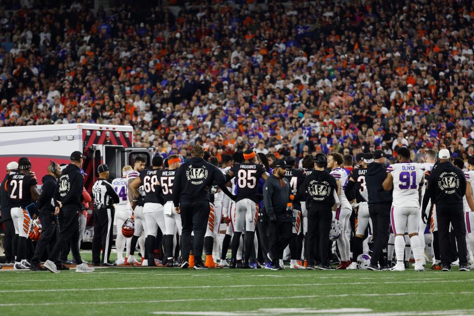 CINCINNATI, OHIO - JANUARY 02: Buffalo Bills and Cincinnati Bengals players look on as Damar Hamlin #3 of the Buffalo Bills is treated by medical personnel after being injured during the first quarter at Paycor Stadium on January 02, 2023 in Cincinnati, Ohio. (Photo by Kirk Irwin/Getty Images)