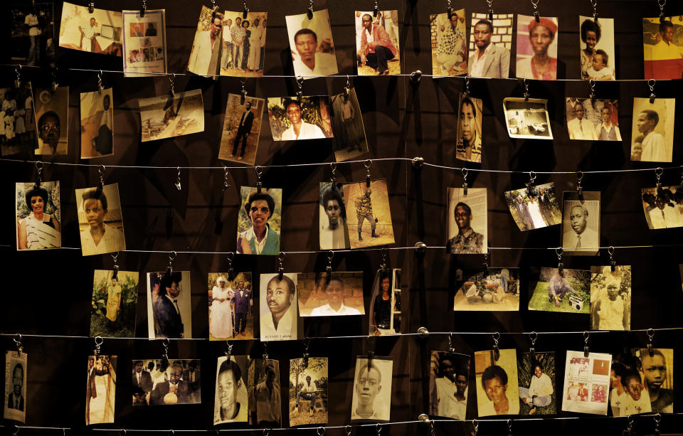 FILE - In this Friday, April 5, 2019 file photo, family photographs of some of those who died hang on display in an exhibition at the Kigali Genocide Memorial centre in the capital Kigali, Rwanda. France and Rwanda are hoping to reset ties scarred by a quarter century of recriminations over the 1994 Rwandan genocide when French President Emmanuel Macron visits the central African country. (AP Photo/Ben Curtis, File)