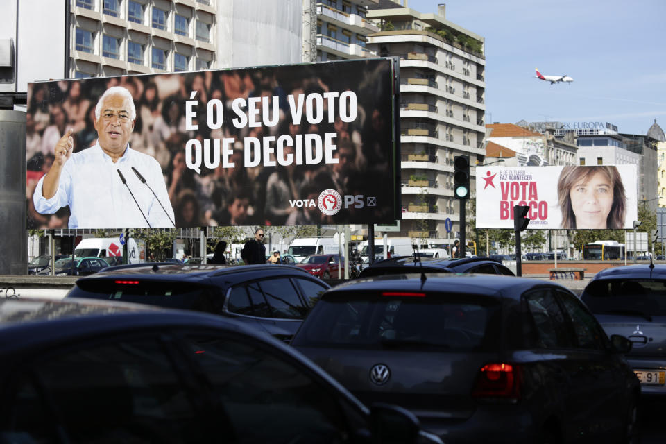 Cars drive past billboards of Portuguese Prime Minister and Socialist Party leader Antonio Costa, left, and Left Bloc leader Catarina Martins, in Lisbon, Thursday, Oct. 3, 2019. Portugal will hold a general election on Oct. 6 in which voters will choose members of the next Portuguese parliament. Slogan on the Socialist's billboard reads in Portuguese, "It's your vote that decides". (AP Photo/Armando Franca)