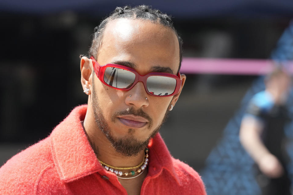 FILE - Mercedes driver Lewis Hamilton of Britain arrives at the Bahrain International Circuit in Sakhir, Bahrain, Thursday, March 2, 2023. Driving for Ferrari next year will be a dream come true for Lewis Hamilton but the seven-time Formula One champion remains “100% committed” to Mercedes until then, he wrote Saturday, Feb. 3, 2024. (AP Photo/Frank Augstein, File)