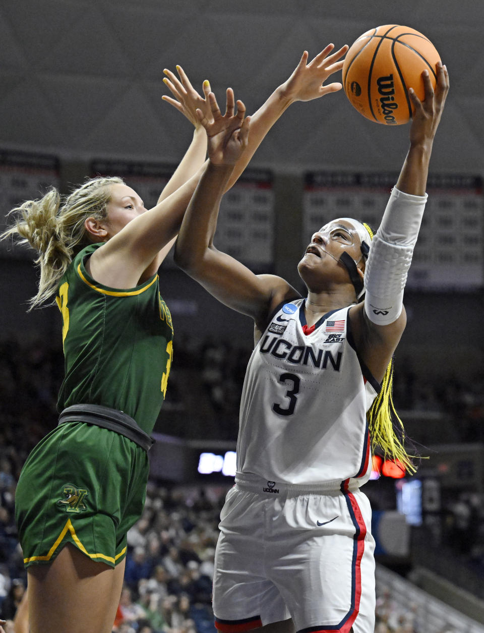 UConn's Aaliyah Edwards (3) goes up for a basket as Vermont's Delaney Richason (33) defends in the second half of a first-round college basketball game in the NCAA Tournament, Saturday, March 18, 2023, in Storrs, Conn. (AP Photo/Jessica Hill)