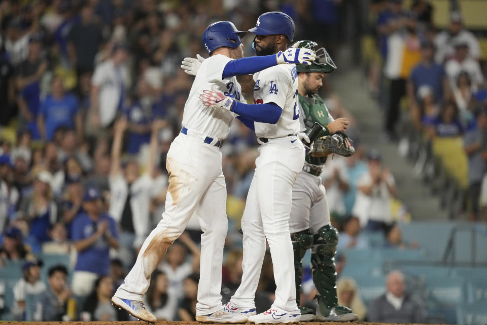 Los Angeles Dodgers' Jason Heyward, right, celebrates with Freddie Freeman after hitting a home run during the sixth inning of a baseball game against the Oakland Athletics in Los Angeles, Wednesday, Aug. 2, 2023. (AP Photo/Ashley Landis)
