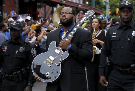 Rodd Bland, son of Bobby "Blue" Bland, carries the iconic Gibson guitar named "Lucille" belonging to the late B.B. King during a procession down Beale Street in Memphis, Tennessee May 27, 2015. REUTERS/Mike Blake