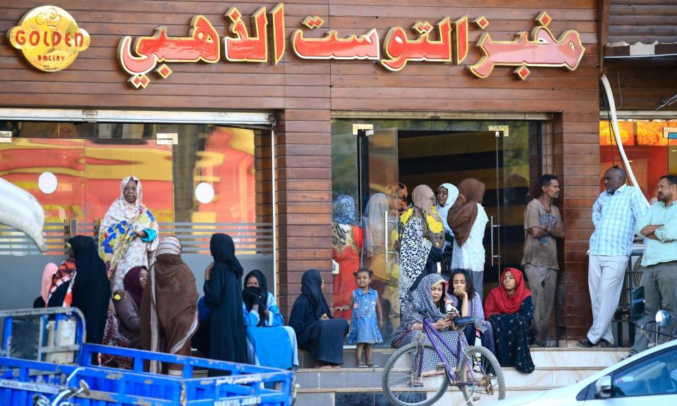 <span>People line up outside a bakery in Khartoum, Sudan. The country has one of the highest debt levels in the developing world.</span><span>Photograph: Ashraf Shazly/AFP/Getty Images</span>