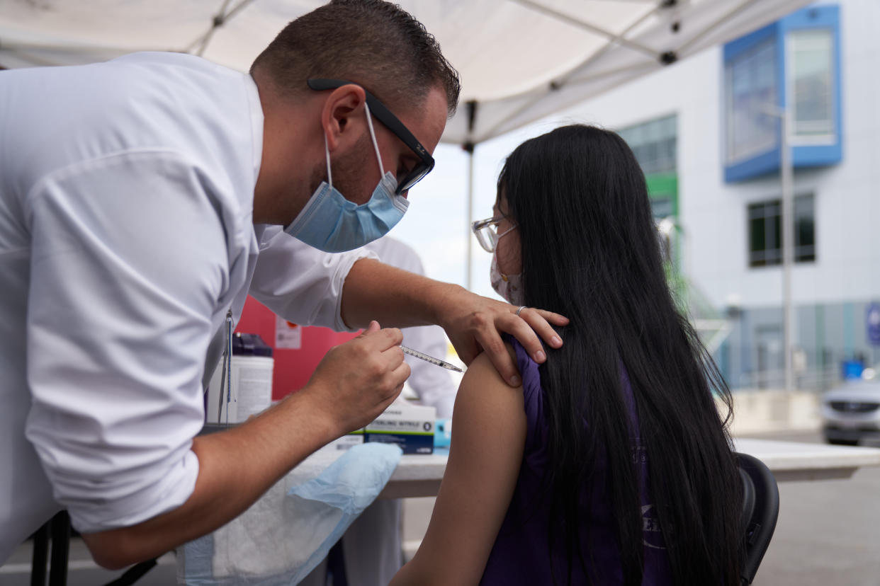 A girl gets a shot at a vaccination event at a school in Boston on Aug. 16.