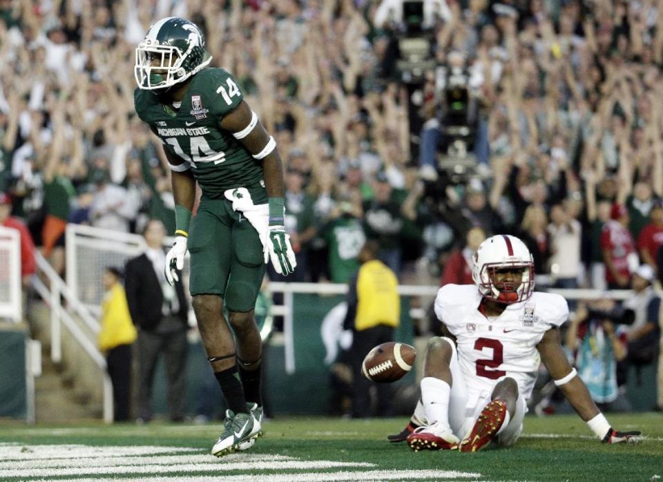 Michigan State wide receiver Tony Lippett celebrates his touchdown past Stanford cornerback Wayne Lyons, during the second half of the Rose Bowl NCAA college football game on Wednesday, Jan. 1, 2014, in Pasadena, Calif. (AP Photo/Jae C. Hong)