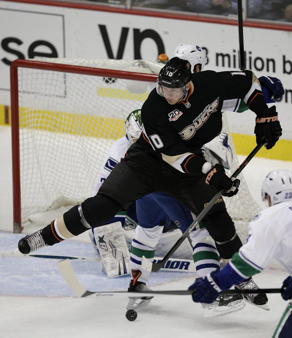 Anaheim Ducks' Corey Perry controls the puck in front of Vancouver Canucks goalie Eddie Lack, of Sweden, during the first period of an NHL hockey game on Wednesday, Jan. 15, 2014, in Anaheim, Calif. (AP Photo/Jae C. Hong)