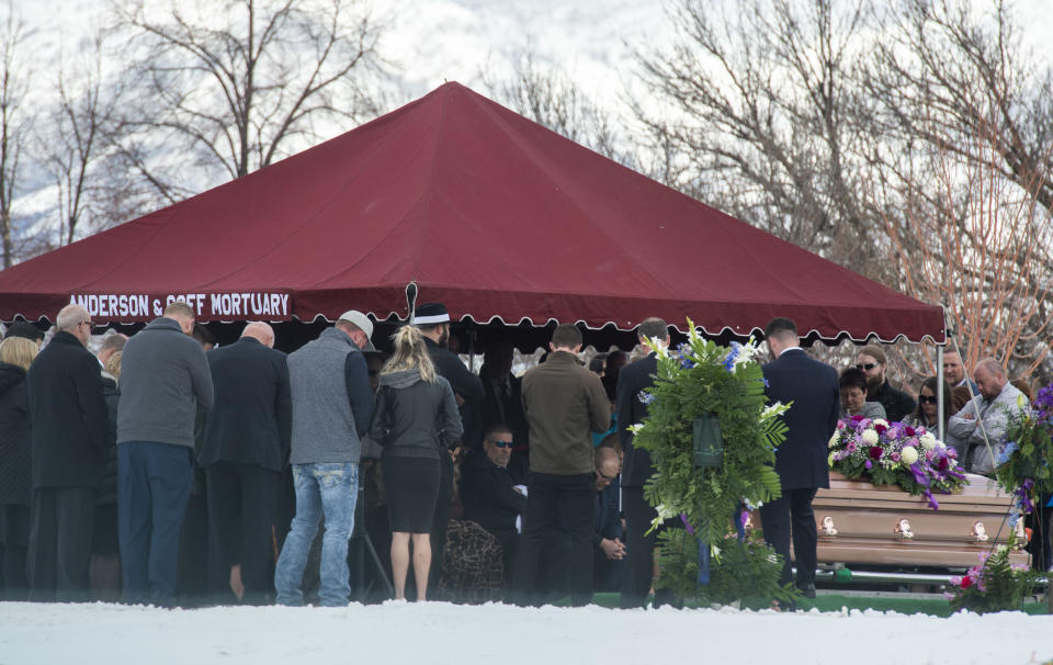 Friends and loved ones gather for the graveside service for Laurie Holt at the Crescent Cemetery in Sandy, Utah, Saturday, Feb. 16, 2019. The family and friends of the Utah woman who spent nearly two years pushing to get her son freed from a Venezuelan jail was remembered for her fearlessness and determination at her funeral. Holt, 50, died unexpectedly Feb. 10 at her Riverton home, less than one year after her son Josh Holt returned to the U.S. after being imprisoned for nearly two years. (Rick Egan/The Salt Lake Tribune via AP)