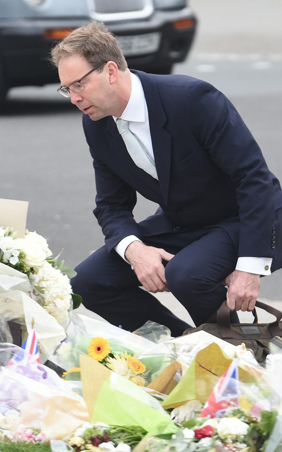 MP Tobias Ellwood looks over the flowers left in tribute to the victims of the attack in Westminster - Credit: Jeremy Selwyn/Evening Standard 