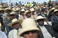 People attend the State Funeral for former Haitian president Rene Preval at the kioske Occide Jeanty, in Port-au-Prince, on March 11, 2017