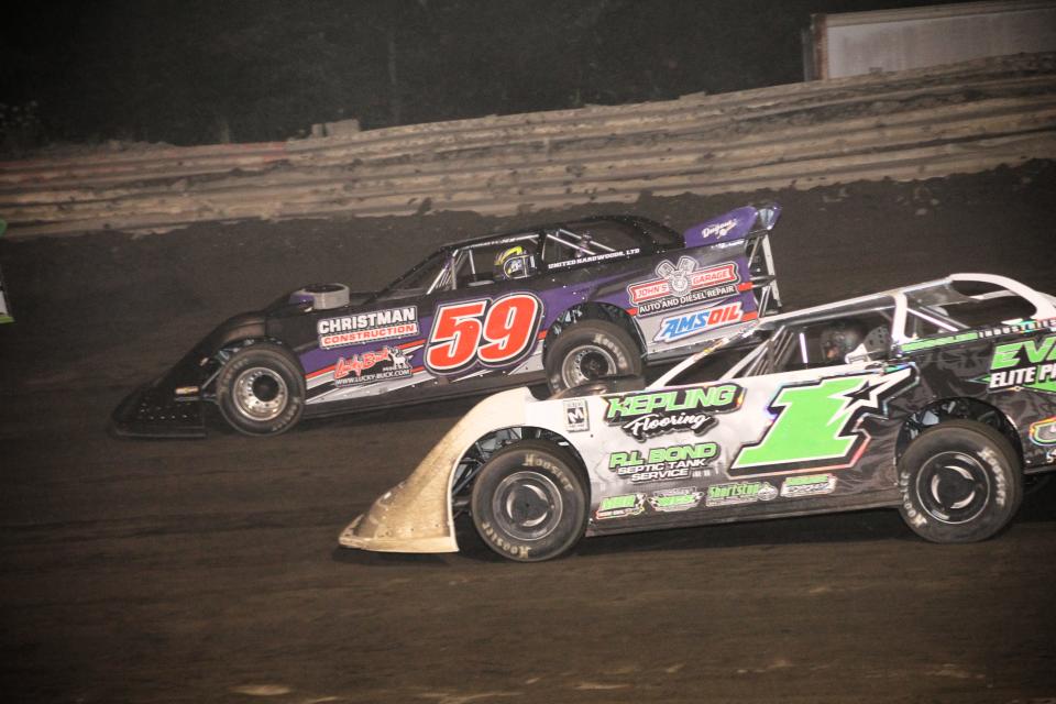Kyle Moore (1) and race leader Larry Bellman (59) of Wooster, race down the backstretch in the Late Model Feature event at Hilltop Speedway on August 4th. Moore captured the feature win, Bellman finished in the runner up position.