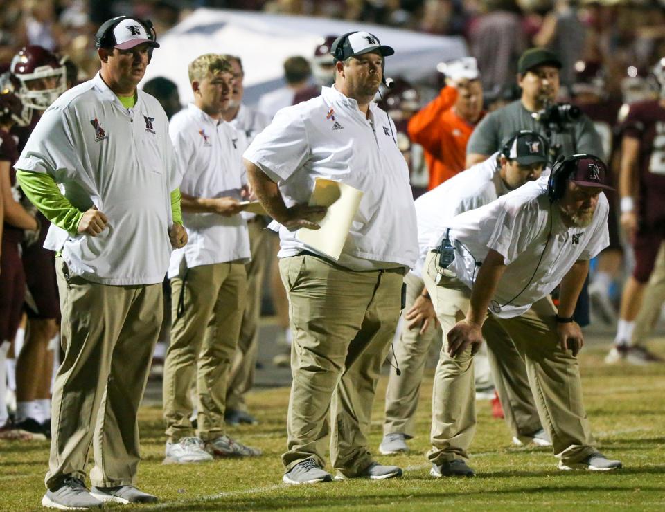 Niceville head football coach Grant Thompson, center,  on the sidelines in a 2021 football game.