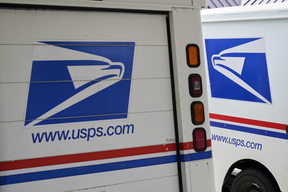 FILE - In this Aug. 18, 2020, photo, mail delivery vehicles are parked outside a post office in Boys Town, Neb. On Friday, Dec. 23, 2022, The Associated Press reported on stories circulating online incorrectly claiming A U.S. Postal Service uniform store was robbed in Tennessee in a scheme to impersonate postal workers and break into homes. (AP Photo/Nati Harnik, File)