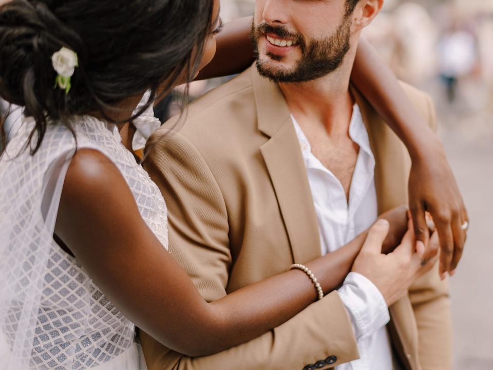 Bride hugs groom in a wedding in Florence, Italy.