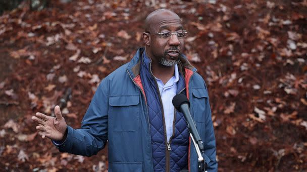 PHOTO: Sen. Raphael Warnock answers questions from the media after speaking during a pre-canvassing event on Dec. 6, 2022, in Norcross, Ga. (Win McNamee/Getty Images)