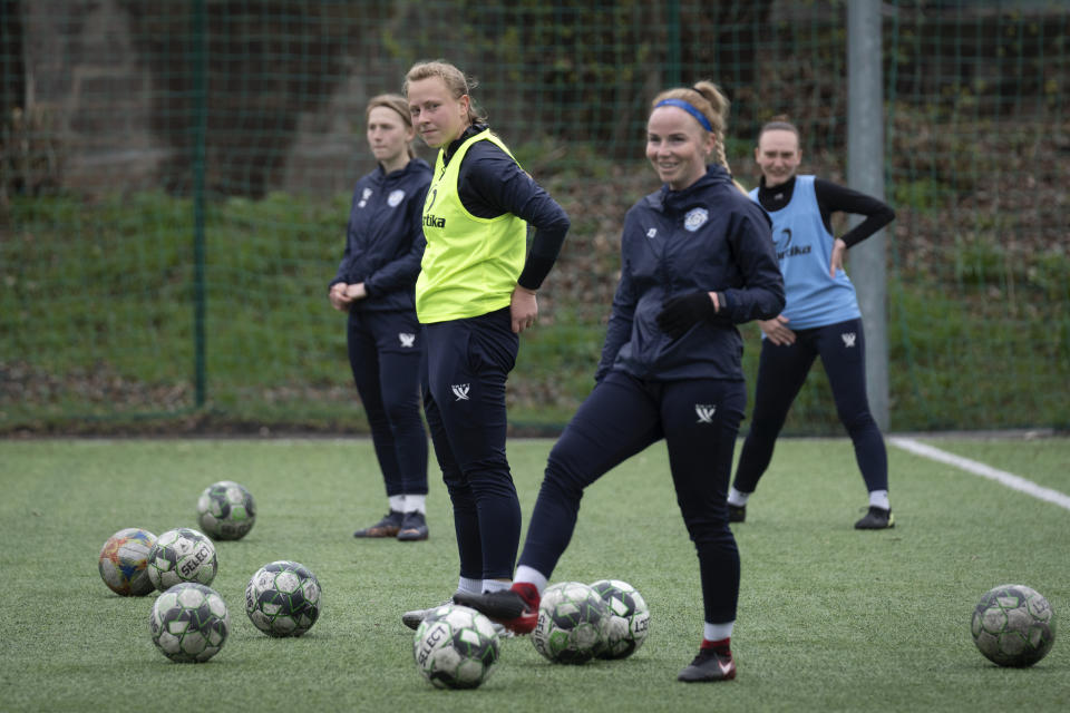 Polina Polukhina, captain of a women's football team from Mariupol, centre, on a training session with her teammates in Kyiv, Ukraine, Thursday, April 13, 2023. After their city was devastated and captured by Russian forces, the team from Mariupol rose from the ashes when they gathered a new team in Kyiv. They continue to play to remind everyone that despite the occupation that will soon hit one year, Mariupol remains a Ukrainian city. (AP Photo/Efrem Lukatsky)
